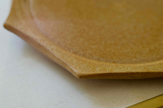 Close-up of a wooden plate on a white surface